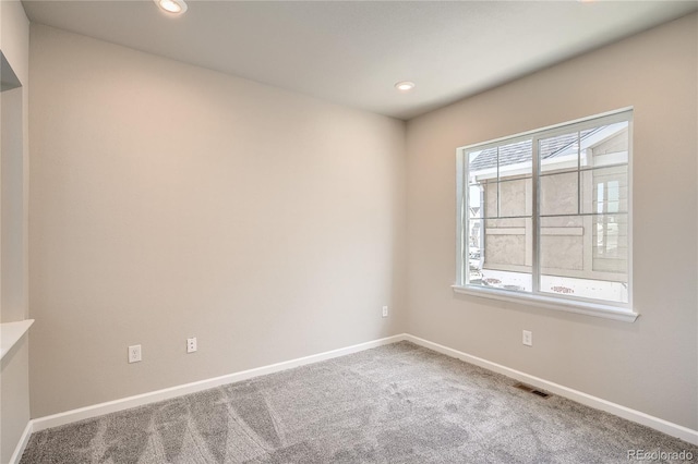 unfurnished room with recessed lighting, baseboards, and carpet