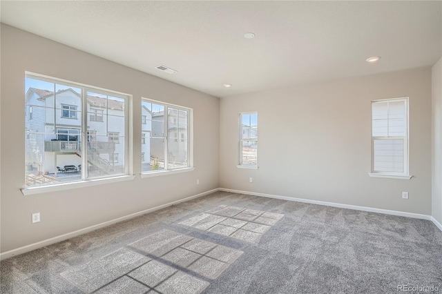 carpeted empty room with recessed lighting, visible vents, and baseboards