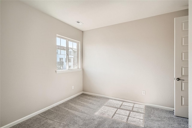 empty room with visible vents, baseboards, and carpet flooring