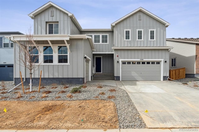 view of front of house featuring an attached garage, board and batten siding, and driveway