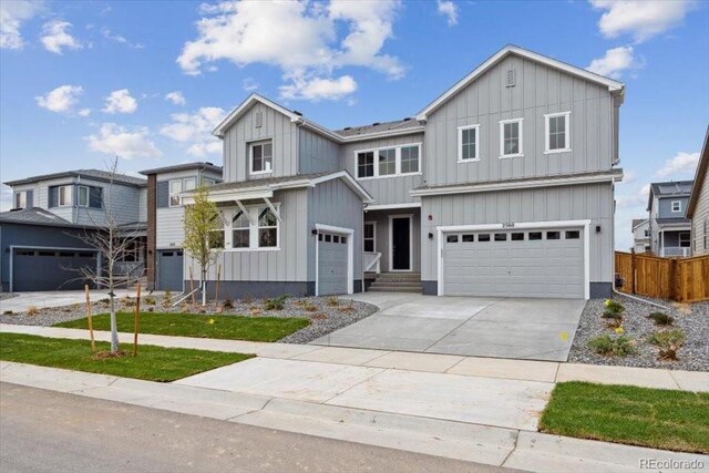 2560 Wesley Ln, Lafayette, CO 80026 - modern inspired farmhouse with an attached garage, board and batten siding, driveway, and fence