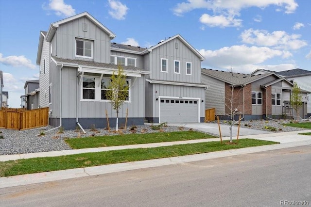 2560 Wesley Ln, Lafayette, CO 80026 - modern farmhouse style home with concrete driveway, board and batten siding, a garage, and fence