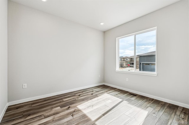 2560 Wesley Ln, Lafayette, CO 80026 - empty room featuring visible vents, wood finished floors, baseboards, and recessed lighting