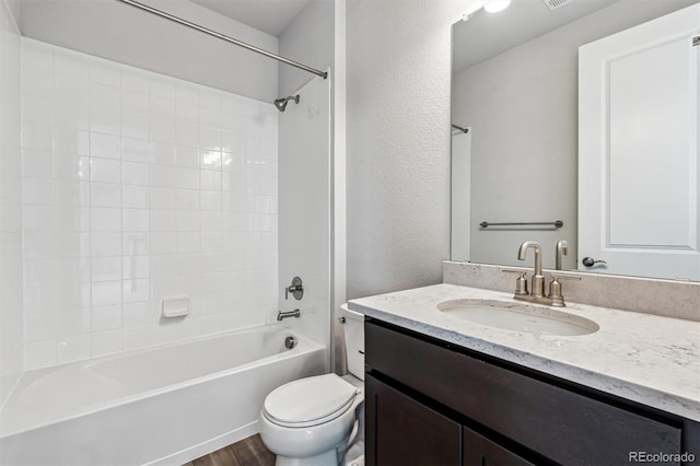 2560 Wesley Ln, Lafayette, CO 80026 - bathroom with toilet, vanity, wood finished floors, shower / bathing tub combination, and a textured wall