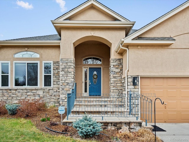 5497 W Prentice Ct, Littleton, CO 80123 - doorway to property featuring stone siding, stucco siding, and a garage