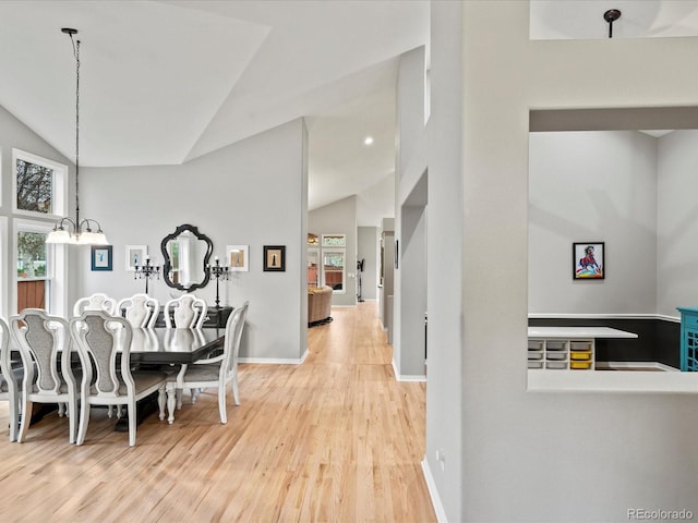 5497 W Prentice Ct, Littleton, CO 80123 - dining space featuring lofted ceiling, plenty of natural light, wood finished floors, and a chandelier