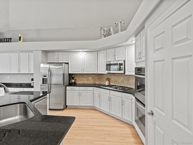 5497 W Prentice Ct, Littleton, CO 80123 - kitchen featuring stainless steel appliances, white cabinetry, and dark stone counters