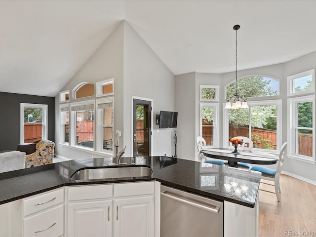 5497 W Prentice Ct, Littleton, CO 80123 - kitchen with stainless steel dishwasher, a chandelier, light wood-type flooring, dark stone countertops, and lofted ceiling