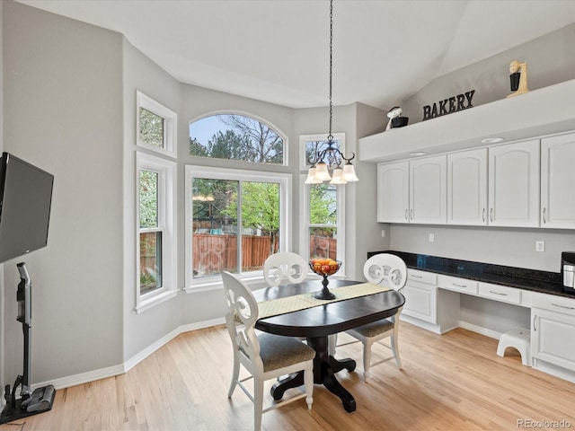 5497 W Prentice Ct, Littleton, CO 80123 - dining space featuring built in desk, light wood-style floors, and a chandelier