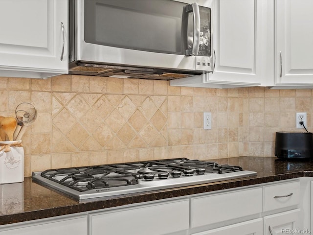 5497 W Prentice Ct, Littleton, CO 80123 - kitchen featuring stainless steel appliances, white cabinetry, and decorative backsplash