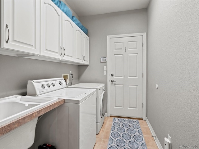 5497 W Prentice Ct, Littleton, CO 80123 - washroom featuring cabinet space, washing machine and dryer, and light tile patterned flooring