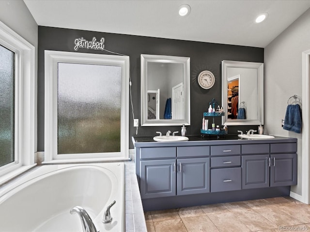 5497 W Prentice Ct, Littleton, CO 80123 - full bathroom with double vanity, a garden tub, and recessed lighting
