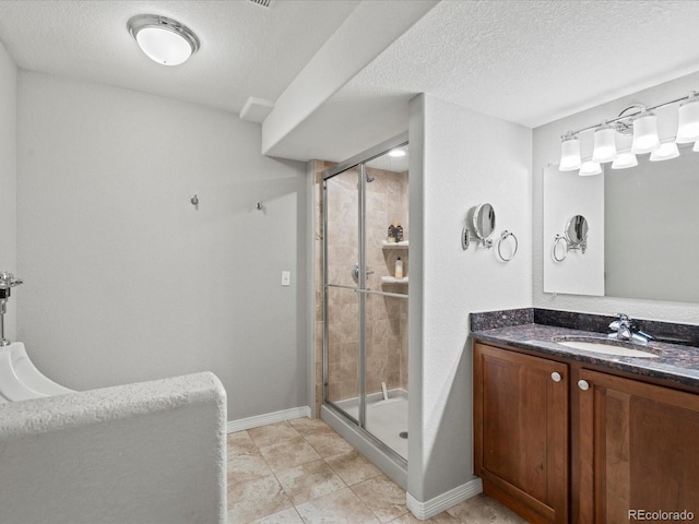 5497 W Prentice Ct, Littleton, CO 80123 - bathroom with a stall shower, vanity, and a textured ceiling