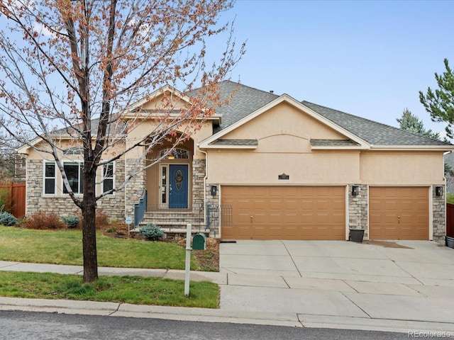 5497 W Prentice Ct, Littleton, CO 80123 - view of front of house with stone siding, a garage, concrete driveway, stucco siding, and a front yard