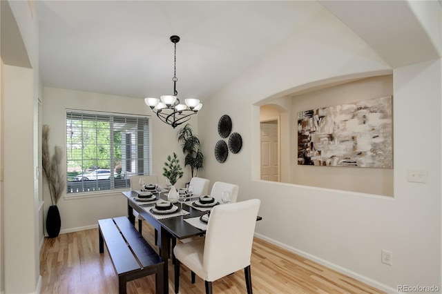 2840 Canyon Crest Ln, Highlands Ranch, CO 80126 - dining area with baseboards, wood finished floors, a chandelier, and arched walkways