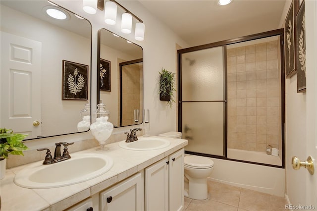 2840 Canyon Crest Ln, Highlands Ranch, CO 80126 - bathroom featuring tile patterned flooring, double vanity, toilet, and enclosed tub / shower combo