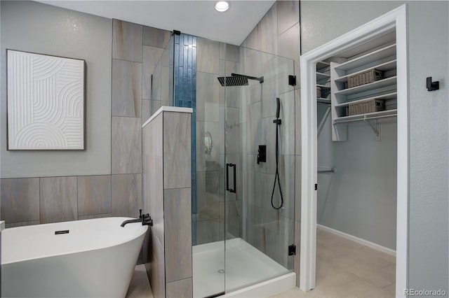 2840 Canyon Crest Ln, Highlands Ranch, CO 80126 - bathroom with a shower stall, a freestanding tub, tile patterned floors, a spacious closet, and recessed lighting