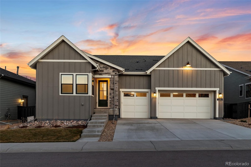 11412 Autumn Moon St, Littleton, CO 80125 - view of front of property with board and batten siding, concrete driveway, and a garage