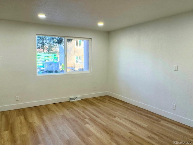 empty room with light hardwood / wood-style floors