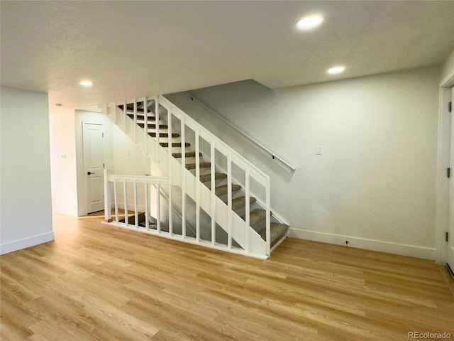 stairway featuring hardwood / wood-style floors