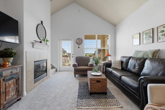 5378 Palomino Ranch Pt Unit 303, Colorado Springs, CO 80922 - carpeted living room featuring high vaulted ceiling and a tiled fireplace