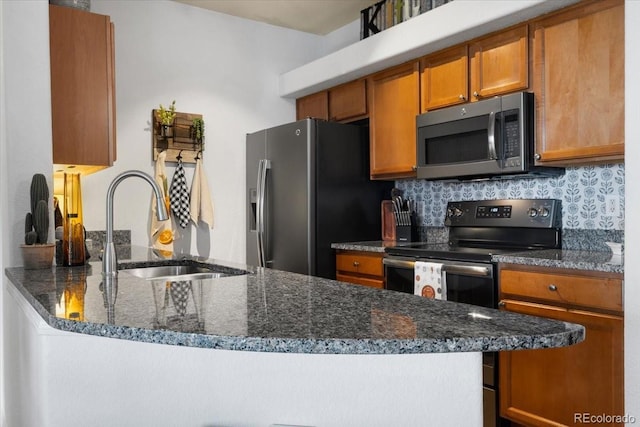 5378 Palomino Ranch Pt Unit 303, Colorado Springs, CO 80922 - kitchen with brown cabinets, decorative backsplash, appliances with stainless steel finishes, a sink, and dark stone counters