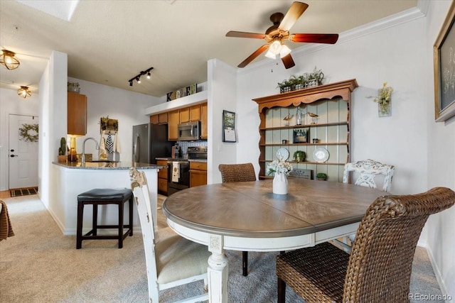 5378 Palomino Ranch Pt Unit 303, Colorado Springs, CO 80922 - dining room with light carpet, track lighting, a ceiling fan, and crown molding