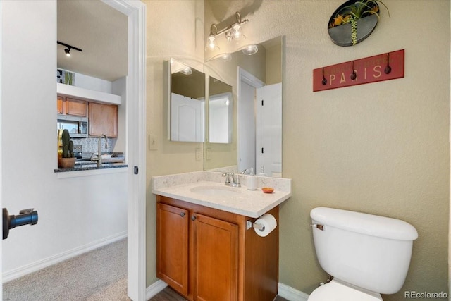 5378 Palomino Ranch Pt Unit 303, Colorado Springs, CO 80922 - half bath featuring toilet, baseboards, and vanity