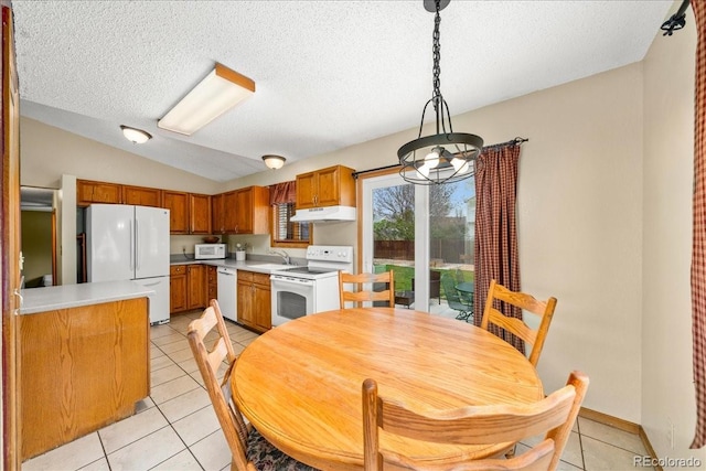 1345 2nd Street Rd, Eaton, CO 80615 - kitchen featuring brown cabinetry, white appliances, under cabinet range hood, a sink, and light tile patterned floors