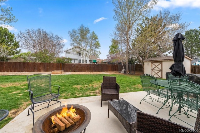 1345 2nd Street Rd, Eaton, CO 80615 - view of patio / terrace featuring a fenced backyard, a storage unit, an outdoor structure, and an outdoor fire pit