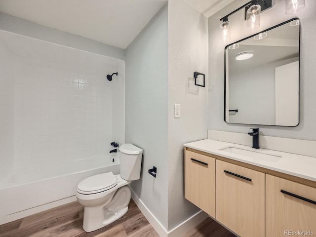 full bathroom with toilet, wood-type flooring, vanity, and shower / tub combination