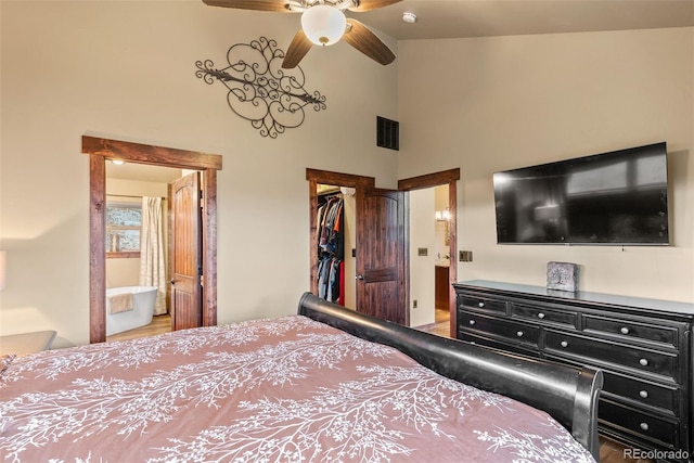 bedroom featuring visible vents, wood finished floors, high vaulted ceiling, a closet, and a spacious closet