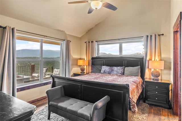 bedroom with a ceiling fan, multiple windows, wood finished floors, and lofted ceiling