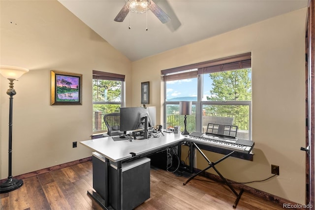 home office featuring a ceiling fan, baseboards, vaulted ceiling, and wood finished floors