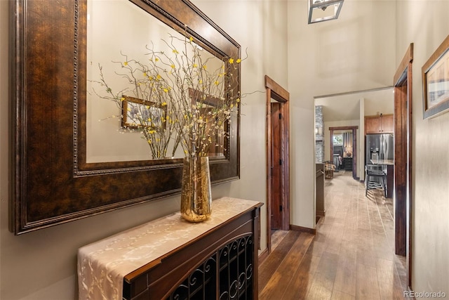 854 Dick Mountain Dr, Bailey, CO 80421 - hall with wood finished floors, baseboards, and a high ceiling
