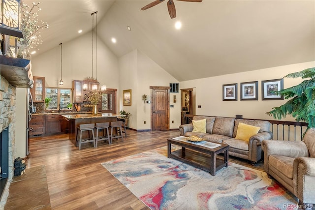 854 Dick Mountain Dr, Bailey, CO 80421 - living room with high vaulted ceiling, ceiling fan, a fireplace, wood finished floors, and recessed lighting