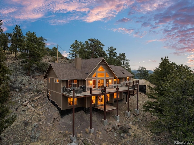 854 Dick Mountain Dr, Bailey, CO 80421 - rear view of house with a chimney, a deck, and roof with shingles