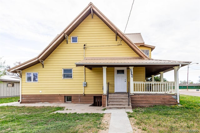 299 4th Ave, Limon, CO 80828 - view of front of property featuring a porch, metal roof, and a front yard