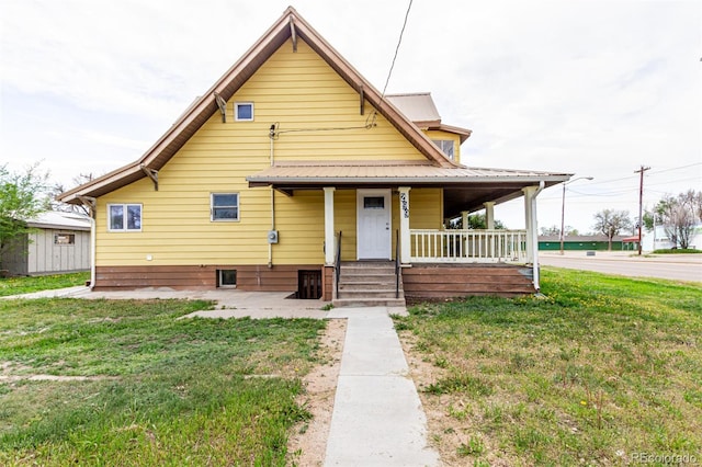 299 4th Ave, Limon, CO 80828 - view of front of home featuring a porch, a front yard, and metal roof