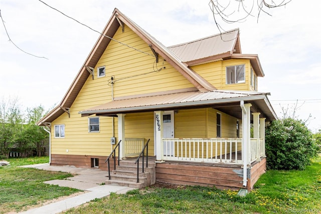 299 4th Ave, Limon, CO 80828 - bungalow with a porch, metal roof, and a front lawn