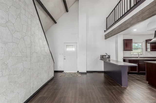 299 4th Ave, Limon, CO 80828 - entrance foyer with a towering ceiling, beam ceiling, dark wood finished floors, and baseboards