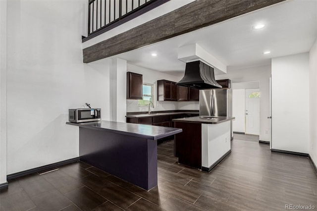 299 4th Ave, Limon, CO 80828 - kitchen with stainless steel appliances, dark brown cabinets, a sink, wood finish floors, and recessed lighting