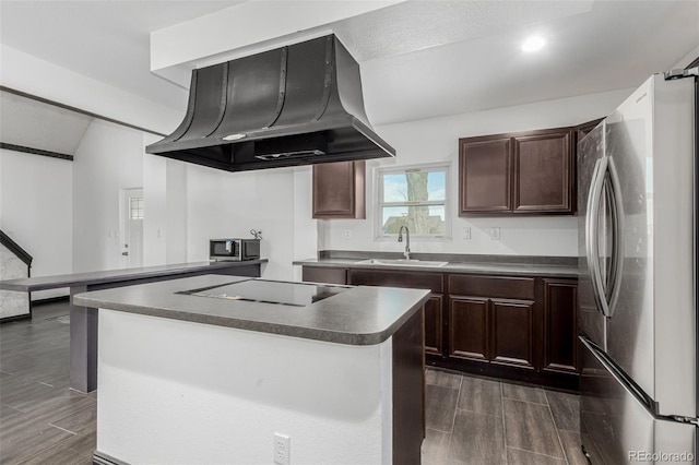 299 4th Ave, Limon, CO 80828 - kitchen with appliances with stainless steel finishes, extractor fan, dark countertops, wood finish floors, and a sink
