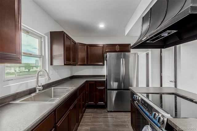 299 4th Ave, Limon, CO 80828 - kitchen featuring stainless steel appliances, a sink, under cabinet range hood, recessed lighting, and dark countertops