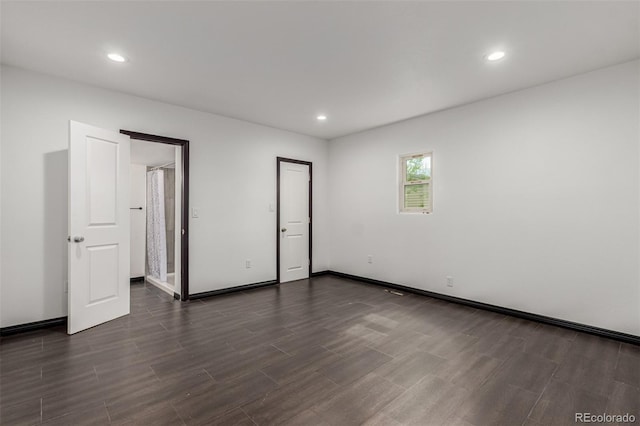 299 4th Ave, Limon, CO 80828 - unfurnished bedroom with dark wood finished floors, recessed lighting, and baseboards