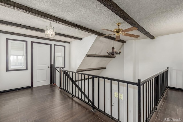 299 4th Ave, Limon, CO 80828 - hall featuring a chandelier, a textured ceiling, an upstairs landing, beamed ceiling, and wood finished floors