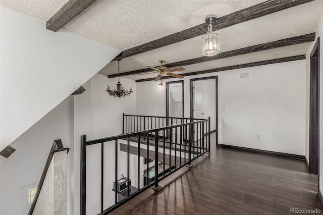 299 4th Ave, Limon, CO 80828 - hallway with an upstairs landing, a chandelier, beamed ceiling, a textured ceiling, and wood finished floors
