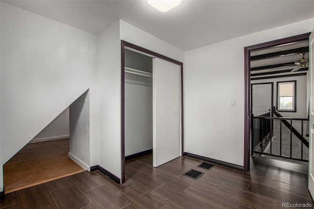 299 4th Ave, Limon, CO 80828 - unfurnished bedroom featuring wood finish floors, a closet, and baseboards