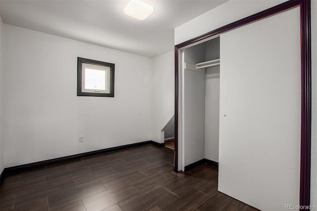 299 4th Ave, Limon, CO 80828 - unfurnished bedroom featuring a closet, dark wood-type flooring, and baseboards