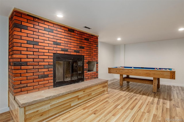 299 4th Ave, Limon, CO 80828 - playroom featuring baseboards, wood finished floors, a fireplace, and recessed lighting